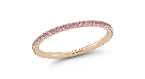 a yellow gold stackable ring lined with pink sapphires