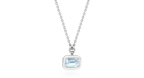 a white gold pendant necklace with an emerald cut blue topaz