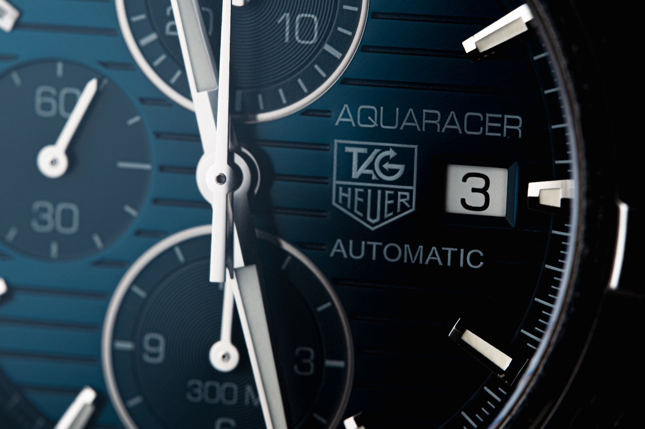 A close-up of a TAG Heuer Aquaracer’s sleek blue dial.