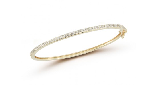 A yellow gold bangle bracelet with micropavé set diamonds, available at Deutsch & Deutsch.