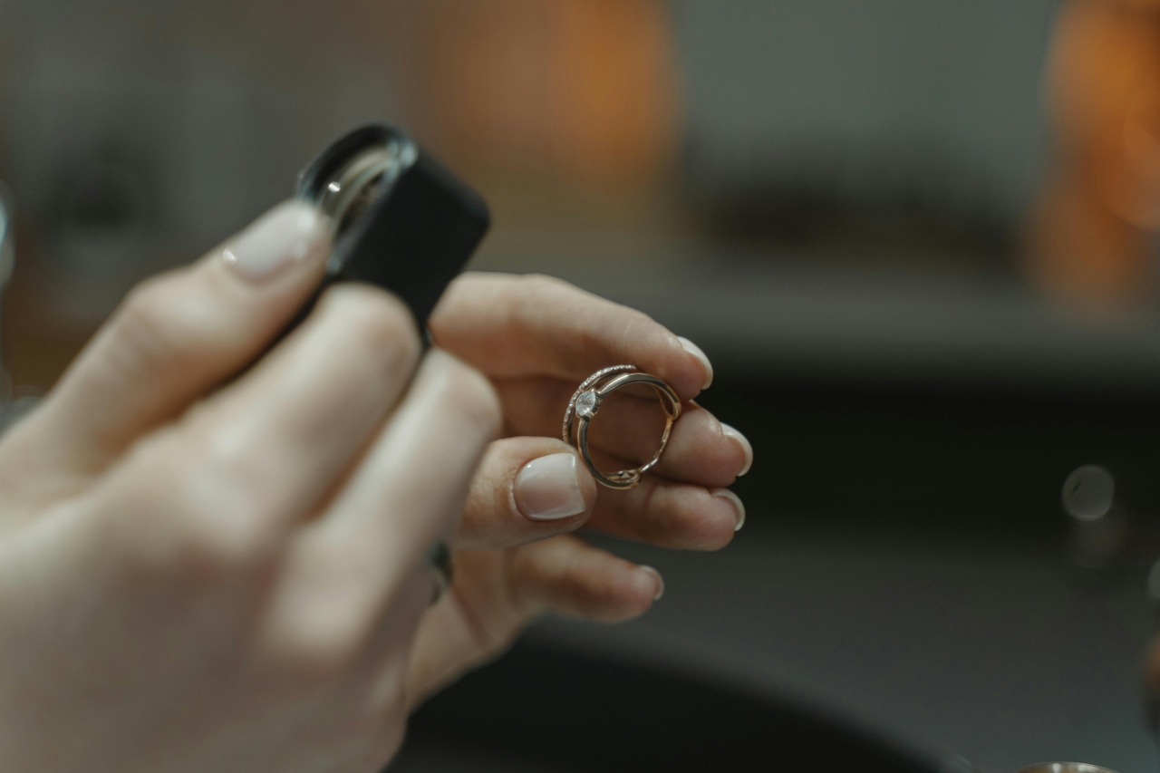 a jeweler inspecting a diamond ring with a magnifying glass